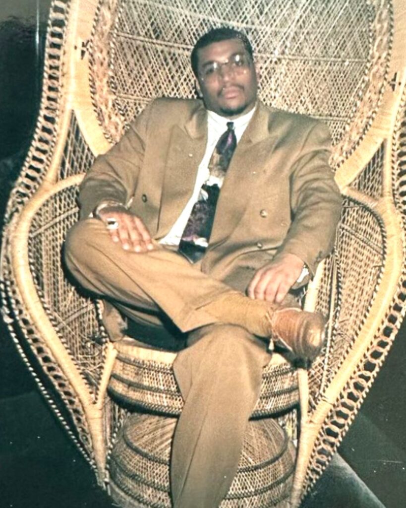 Terry Lee Flenory Sitting In Brown Suit